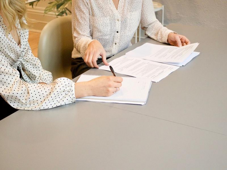 People discussing documents at a table