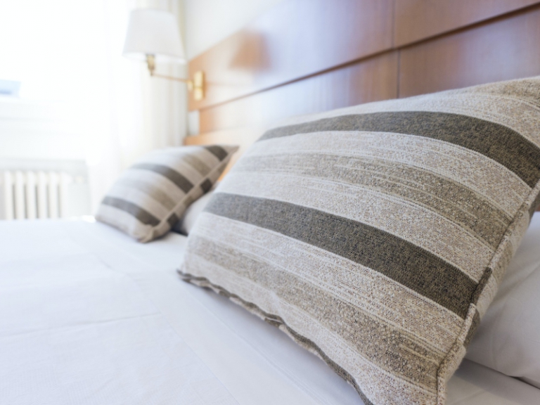 Striped pillows on a bed in a bedroom