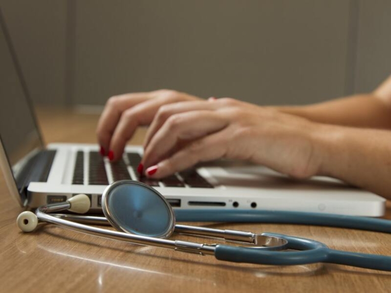 Laptop and stethoscope on a medical professional’s desk