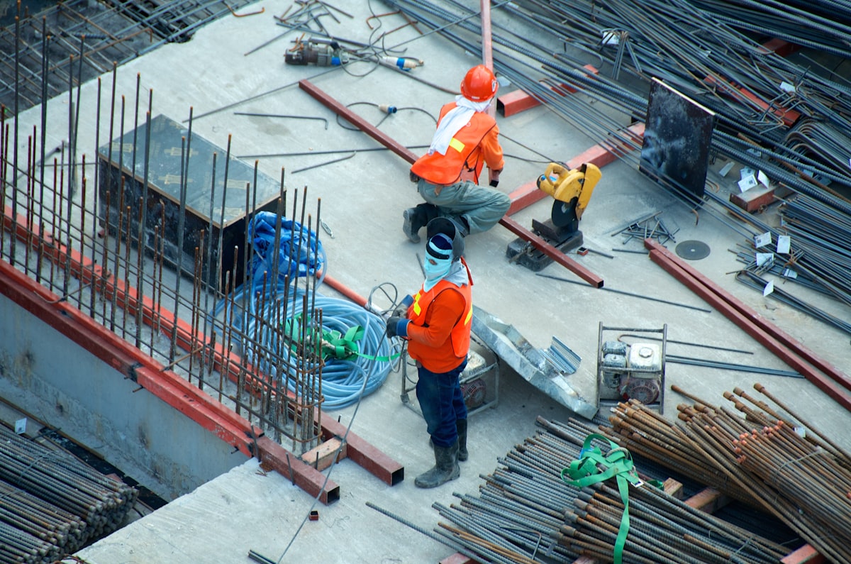 Construction workers at a Singapore building site Work Permit MYE DRC 2026