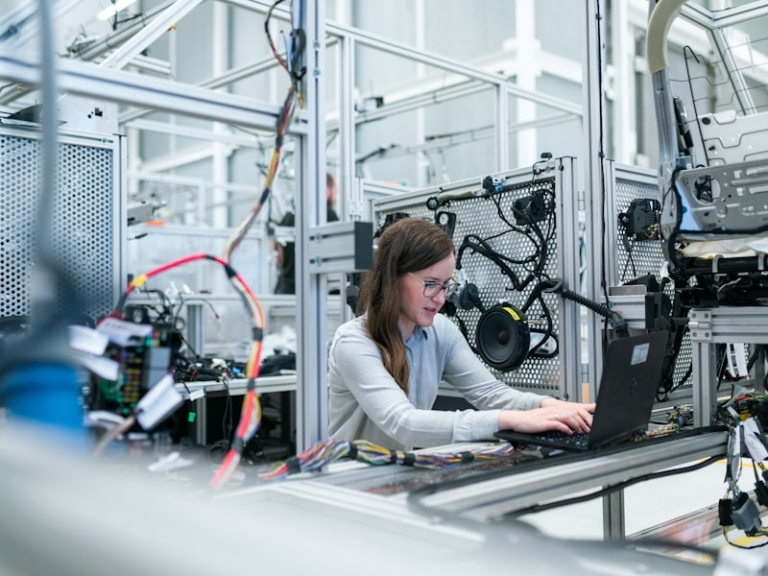 Worker operating equipment in a manufacturing facility