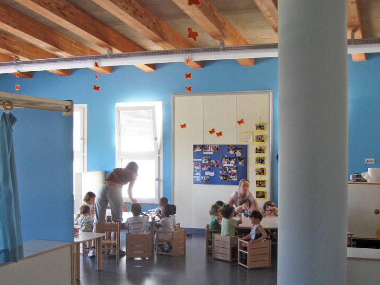 Foreign early childhood educator teaching young children in a Singapore preschool classroom