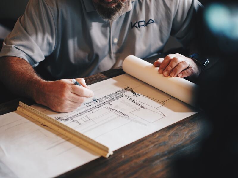 Foreign structural engineer reviewing Employment Pass and PEB registration paperwork in Singapore