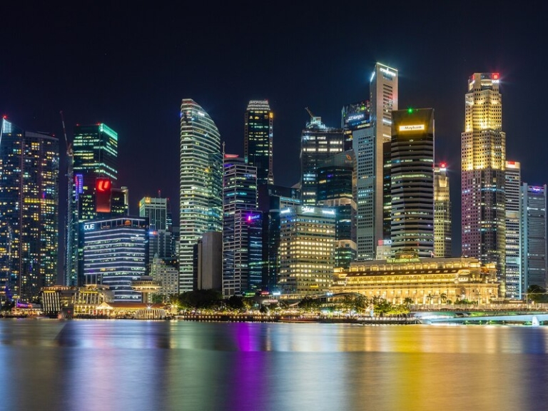 Singapore central business district illuminated beside Marina Bay at night