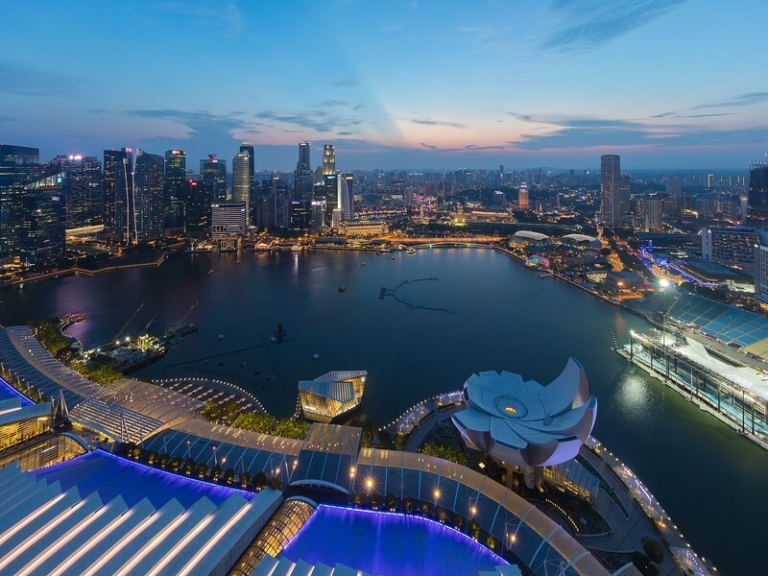 Marina Bay and the Singapore skyline viewed from above at dusk