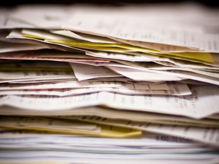 S Pass promotion pay rise application paperwork on an office desk