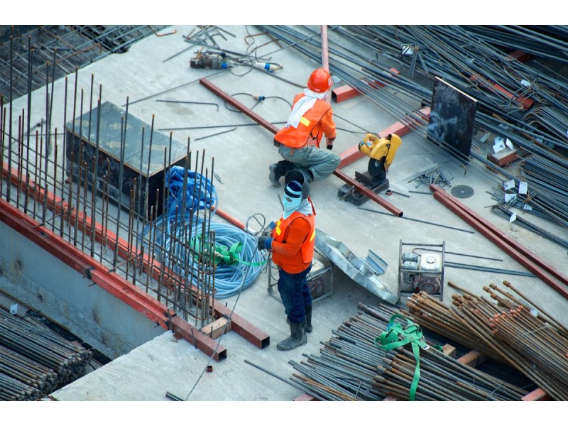 Construction workers at a Singapore building site Work Permit MYE DRC 2026