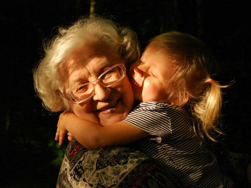 Grandmother hugging a young child, illustrating an LTVP for parents of EP holders in Singapore