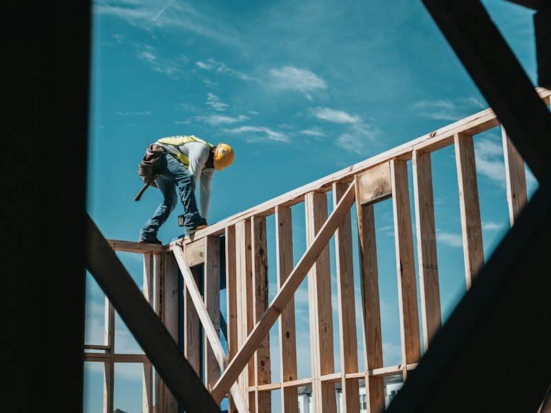 Construction worker in a hard hat on a building frame